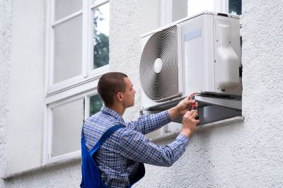 Technician Installing Wall Ac